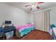 Cozy bedroom with colorful bedding, ceiling fan, and carpeted floor at 3994 Ridgewood Ave, Las Vegas, NV 89120