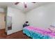 Modest bedroom with a single bed, ceiling fan, and sliding closet doors at 3994 Ridgewood Ave, Las Vegas, NV 89120