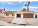 Charming single-story home featuring a two-car garage, desert landscaping, and palm trees at 3994 Ridgewood Ave, Las Vegas, NV 89120