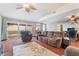 Expansive living room with plush furniture, fireplace, and sliding glass doors to backyard at 3994 Ridgewood Ave, Las Vegas, NV 89120