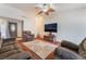 Cozy living room with sofa set, television, and large decorative rug at 3994 Ridgewood Ave, Las Vegas, NV 89120