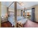 Primary bedroom with a four-poster bed, bench and sliding glass door with view to the pool area at 3994 Ridgewood Ave, Las Vegas, NV 89120