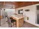 Charming outdoor covered bar area featuring tile countertop, brick accents, and comfortable seating for entertaining at 3994 Ridgewood Ave, Las Vegas, NV 89120