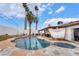 Backyard pool with spa, covered patio area, and palm trees at 3994 Ridgewood Ave, Las Vegas, NV 89120
