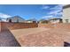 The backyard is surrounded by a brick wall with some rocks and bricks in the yard at 406 Misterioso St, Henderson, NV 89011