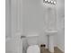 Simple powder room featuring a pedestal sink, toilet, and neutral-colored walls with modern lighting at 406 Misterioso St, Henderson, NV 89011