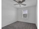 Cozy carpeted bedroom featuring a ceiling fan and a window letting in natural light at 406 Misterioso St, Henderson, NV 89011
