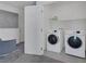 Bright laundry room features modern washer and dryer, white shelving, and neutral color palette at 406 Misterioso St, Henderson, NV 89011