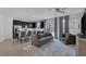 Open-concept living area featuring tile flooring, modern furniture, and ample natural light at 406 Misterioso St, Henderson, NV 89011