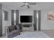Bright living room with modern accents, plush rug, and a stylish entertainment center at 406 Misterioso St, Henderson, NV 89011