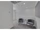 Cozy loft area with two gray chairs, a glass table, and neutral walls at 406 Misterioso St, Henderson, NV 89011