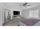 Comfortable main bedroom features plush carpet, ceiling fan, and stylish mirrored dresser at 406 Misterioso St, Henderson, NV 89011