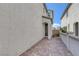 Side yard showcasing a paver walkway, stucco wall, and access to the home's entrance at 406 Misterioso St, Henderson, NV 89011