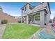 Spacious backyard featuring a well-maintained lawn and covered patio at 4163 Peaceful Meadow St, Las Vegas, NV 89135