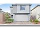 Modern two-story home featuring a neutral color scheme, well-maintained landscaping, and a spacious two-car garage at 4163 Peaceful Meadow St, Las Vegas, NV 89135