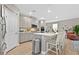 Stylish kitchen with gray cabinets, a kitchen island with seating, and modern stainless steel appliances at 4163 Peaceful Meadow St, Las Vegas, NV 89135