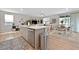 Open-concept kitchen and dining area with island, stainless appliances, and wood floors at 4163 Peaceful Meadow St, Las Vegas, NV 89135