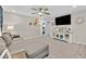 Relaxing living area with a plush sofa, media console, and a ceiling fan at 4163 Peaceful Meadow St, Las Vegas, NV 89135