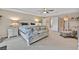 Spacious main bedroom features neutral color palette, ceiling fan, and sitting area at 4163 Peaceful Meadow St, Las Vegas, NV 89135