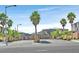 Street view of a modern community with palm trees and well-maintained landscaping at 4163 Peaceful Meadow St, Las Vegas, NV 89135