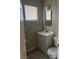 Compact bathroom featuring a vanity, toilet, and a window for natural light at 4321 Mayflower Ln, Las Vegas, NV 89107