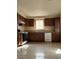 Functional kitchen featuring wooden cabinets, a white dishwasher, and essential appliances at 4321 Mayflower Ln, Las Vegas, NV 89107