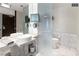 Modern bathroom with double sinks, wall-mounted TV, and separate toilet area at 4381 W Flamingo Rd # 24304, Las Vegas, NV 89103
