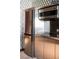 Contemporary kitchen features stainless steel refrigerator, microwave, and sleek countertops with modern wallpaper accents at 4381 W Flamingo Rd # 24304, Las Vegas, NV 89103