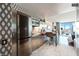 Modern kitchen showcases stainless steel appliances, sleek dining table, and city views, blending style with functionality at 4381 W Flamingo Rd # 24304, Las Vegas, NV 89103