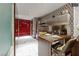 Contemporary kitchen boasts stainless steel appliances, a dining table, patterned wallpaper, and access to storage closets at 4381 W Flamingo Rd # 24304, Las Vegas, NV 89103