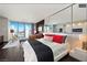 Chic bedroom with mirrored wall offering city views, a comfortable king bed, and elegant contemporary decor at 4381 W Flamingo Rd # 24304, Las Vegas, NV 89103