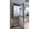 Stainless steel refrigerator with open door showcasing spacious interior shelving at 4381 W Flamingo Rd # 24304, Las Vegas, NV 89103