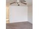 A spacious living room with carpeted floors, a ceiling fan, and neutral walls, perfect for relaxing at 4732 Lone Grove Dr, Las Vegas, NV 89139