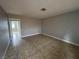 Living room featuring neutral-toned walls, tiled floor and access to another room at 500 S 13Th St # C27, Las Vegas, NV 89101