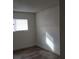 Cozy bedroom featuring wood-look flooring and a bright window at 5126 Golden Ln # A, Las Vegas, NV 89119