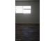 Bright bedroom features modern, wood-look flooring and a sunny window at 5126 Golden Ln # A, Las Vegas, NV 89119