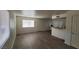 Spacious living room with updated wood-look flooring and natural light from window at 5126 Golden Ln # A, Las Vegas, NV 89119