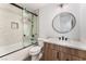 Modern bathroom with shower-tub combo, vanity with storage, and decorative mirror at 5537 Sentinel Bridge St, Las Vegas, NV 89130