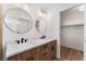 Bathroom featuring a double vanity, modern fixtures, a glass-enclosed shower and a walk-in closet at 5537 Sentinel Bridge St, Las Vegas, NV 89130
