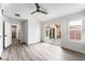 Bedroom features wood-look floors, a modern ceiling fan and sliding glass doors leading to the backyard at 5537 Sentinel Bridge St, Las Vegas, NV 89130