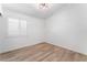 Small and bright bedroom with wood-style floors and a window with shutters at 5537 Sentinel Bridge St, Las Vegas, NV 89130