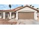 Charming single-story home with a low-pitched tile roof, desert landscaping and attached garage at 5537 Sentinel Bridge St, Las Vegas, NV 89130