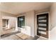Inviting front porch featuring a modern front door with glass panels and side window at 5537 Sentinel Bridge St, Las Vegas, NV 89130