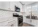Close-up of a modern kitchen showcasing stainless steel appliances and white herringbone tile backsplash at 5537 Sentinel Bridge St, Las Vegas, NV 89130