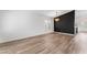 Bright living room showcasing modern flooring, stylish light fixture, and black accent wall at 5537 Sentinel Bridge St, Las Vegas, NV 89130