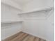 Bright walk-in closet featuring white walls, wood-style flooring, and ample storage space at 5537 Sentinel Bridge St, Las Vegas, NV 89130
