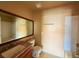 Well-lit bathroom with granite countertop, a large mirror, and a shower-tub combo at 5576 W Rochelle Ave # 38B, Las Vegas, NV 89103