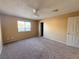 Bedroom featuring neutral carpet, ceiling fan, a window, and a closet for storage at 5576 W Rochelle Ave # 38B, Las Vegas, NV 89103