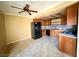 Kitchen with black appliances, wood cabinets, and a ceiling fan above a dining area at 5576 W Rochelle Ave # 38B, Las Vegas, NV 89103