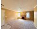 Cozy living room with fireplace, neutral carpet, and natural light from large windows at 5576 W Rochelle Ave # 38B, Las Vegas, NV 89103